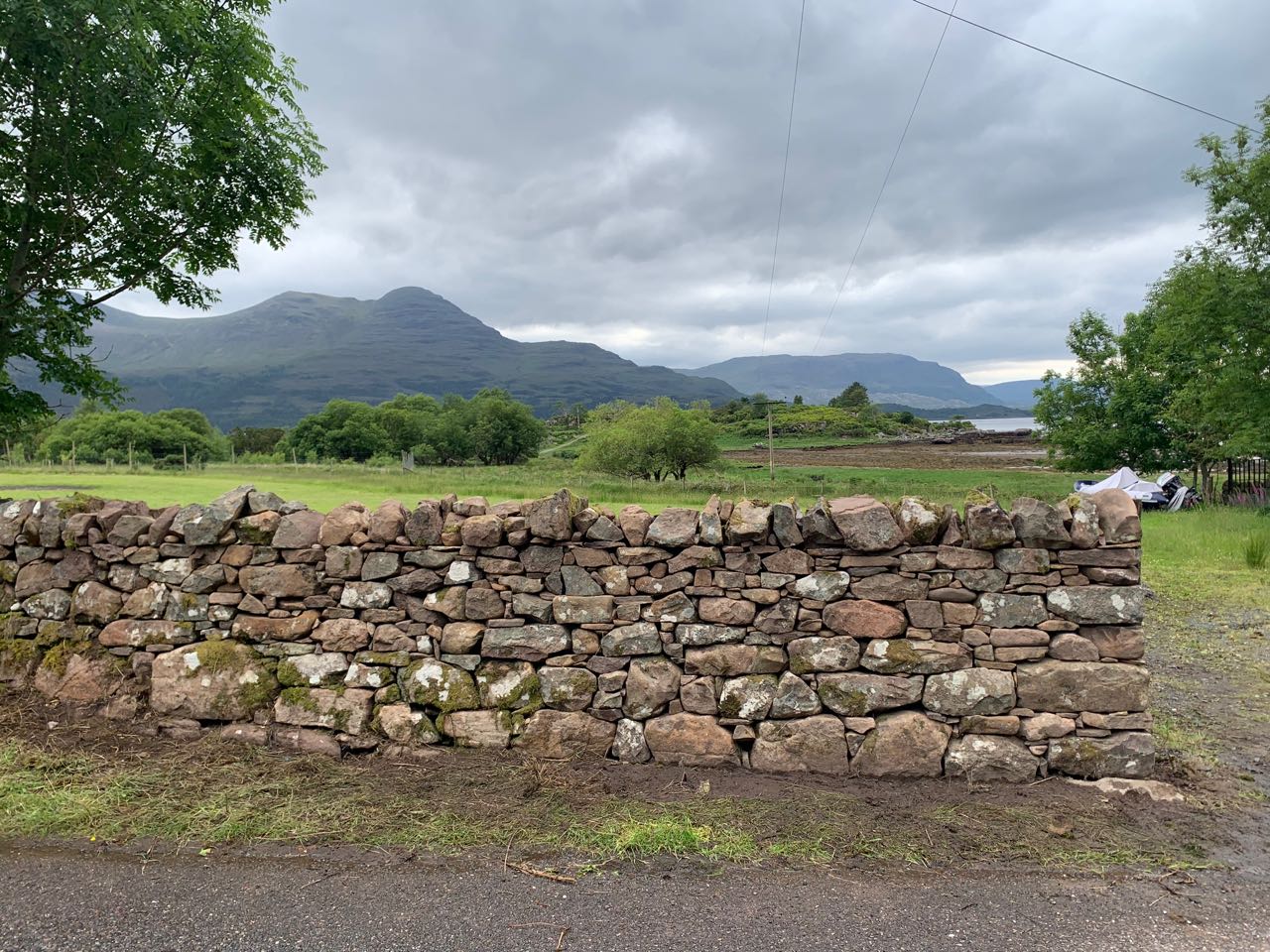 Several meters of newly repaired dry stone wall in Torridon, including a cheek end.